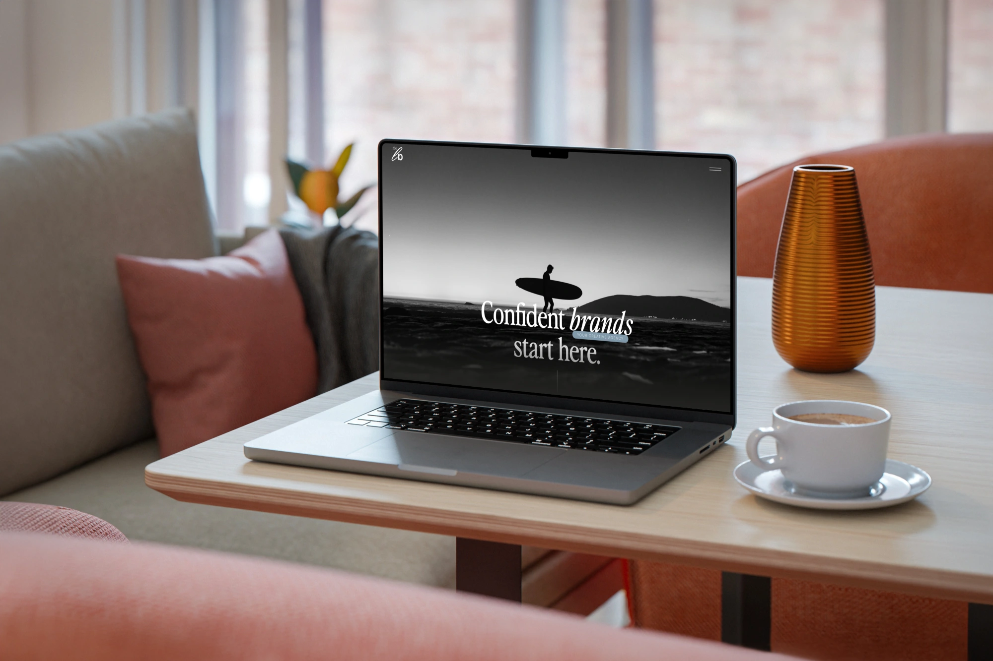 Lightbulb Creative website with a monochrome surfing photograph, displayed on a laptop